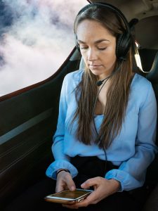 A woman works on business while fly on a Direct2 air taxi